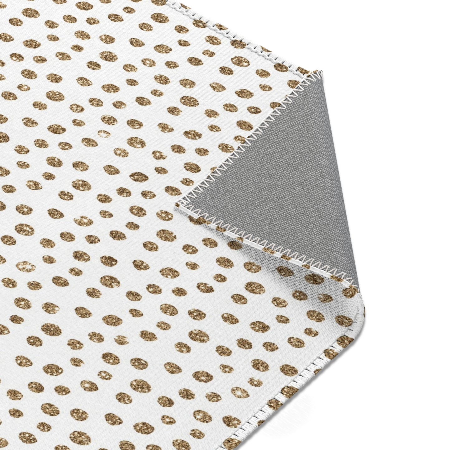 White and gold polka dot throw blanket with gray reverse and zigzag stitching