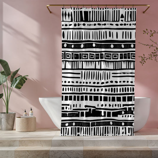 Black and white patterned shower curtain hanging in a bathroom with a pink wall.