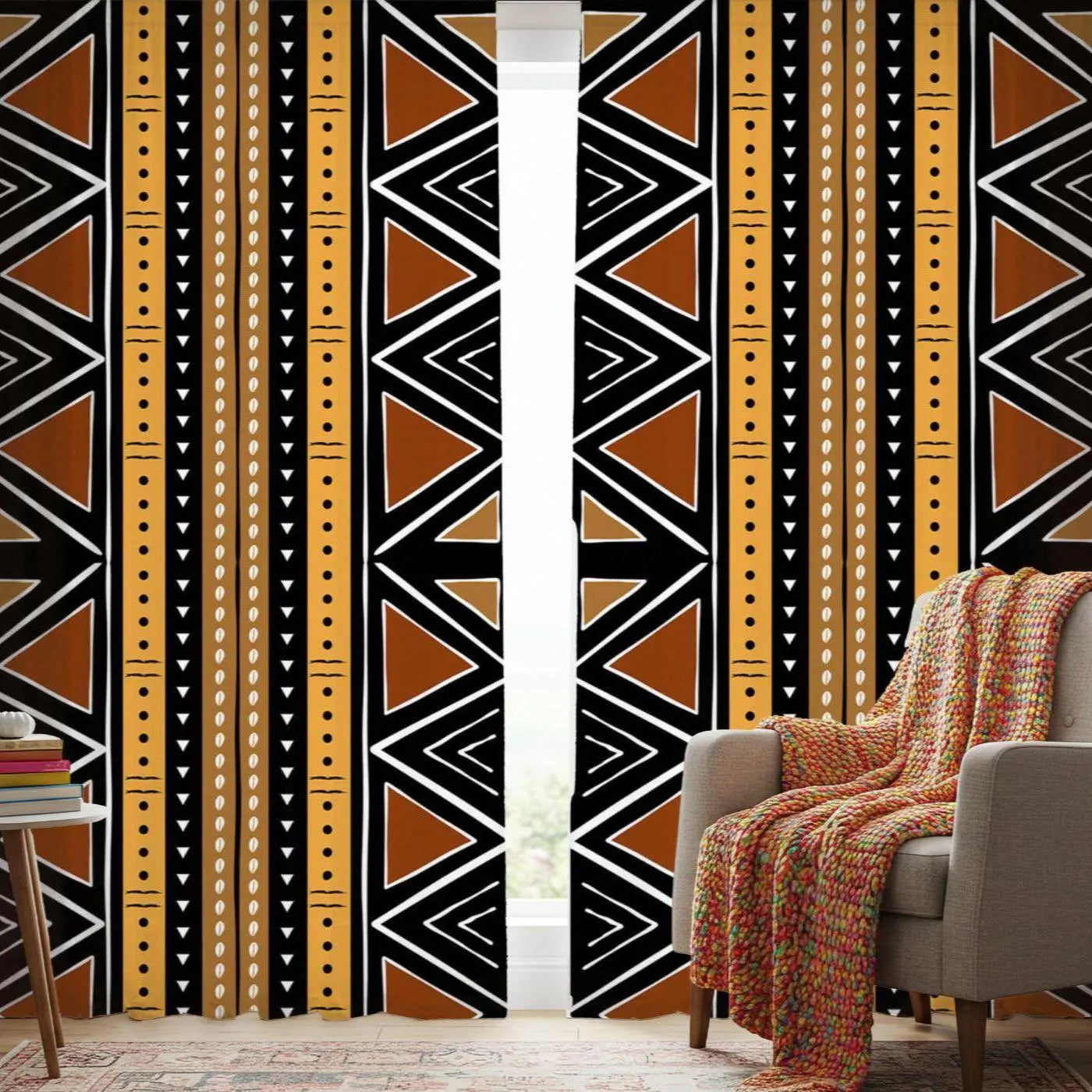 Curtains with a geometric pattern in a room with a chair and books.
