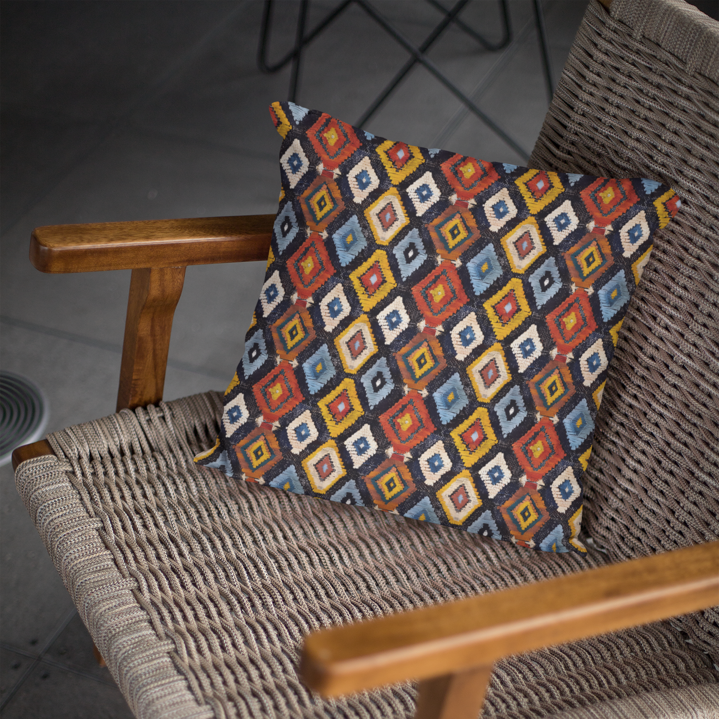 Decorative pillow with geometric pattern on a wicker chair