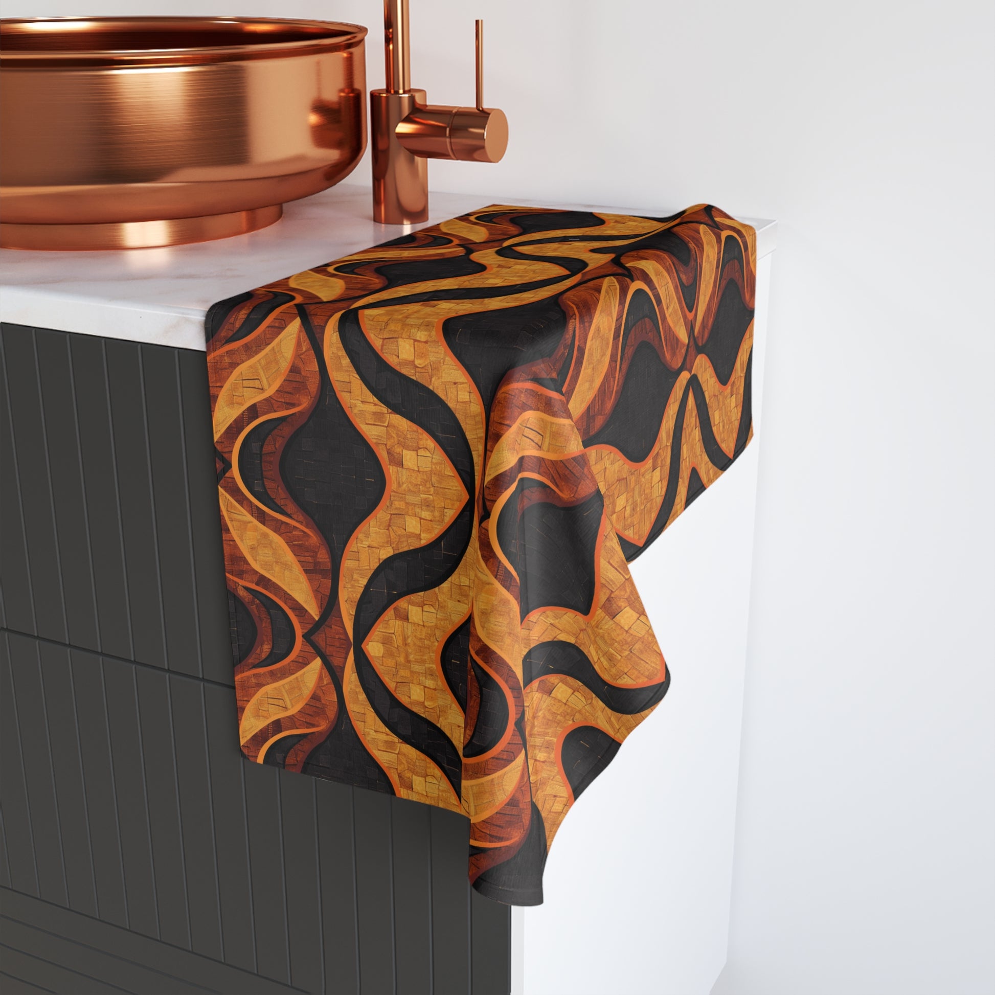 Mudcloth patterned towel draped over a bathroom cabinet with copper fixtures.