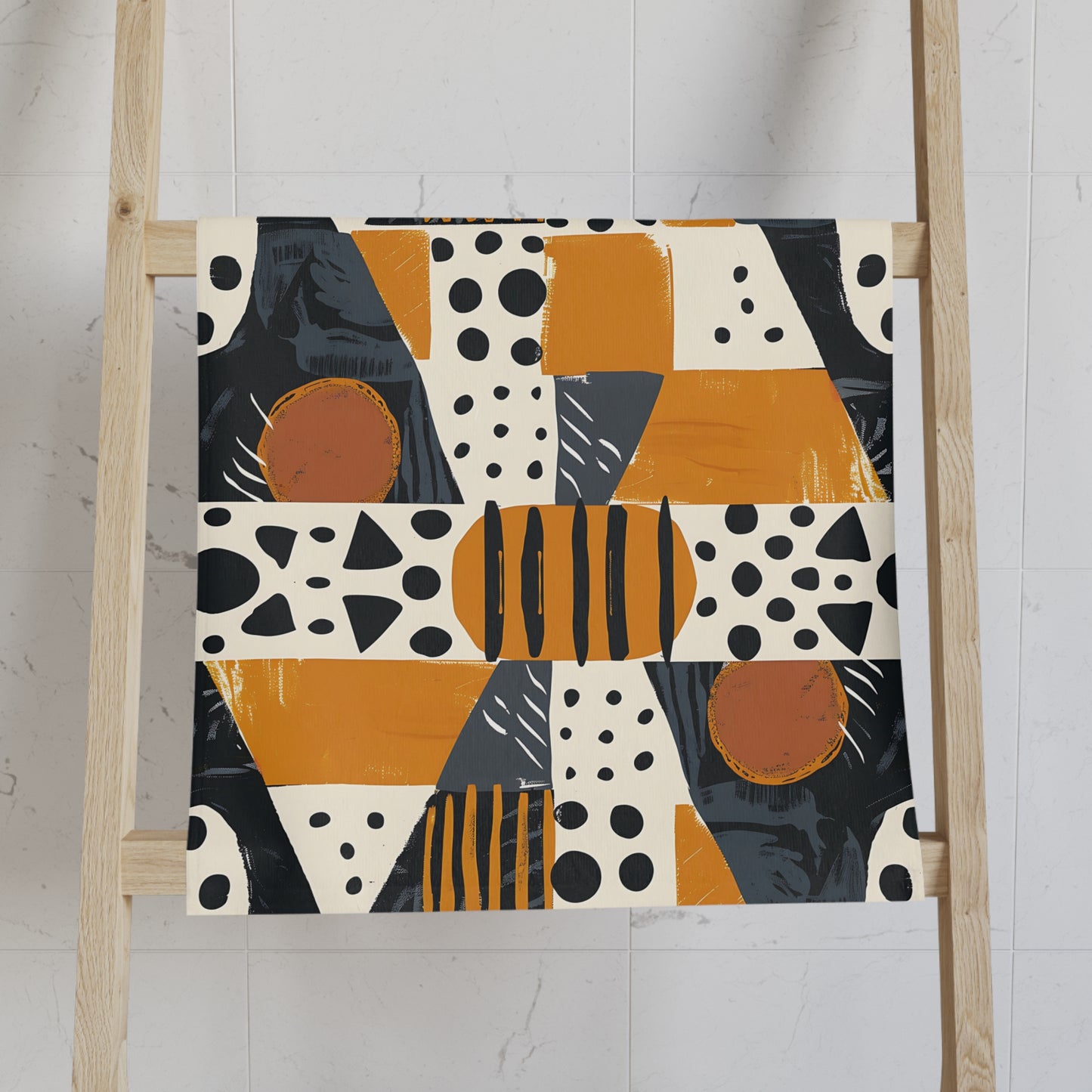 Abstract patterned towel on a wooden ladder against a white wall