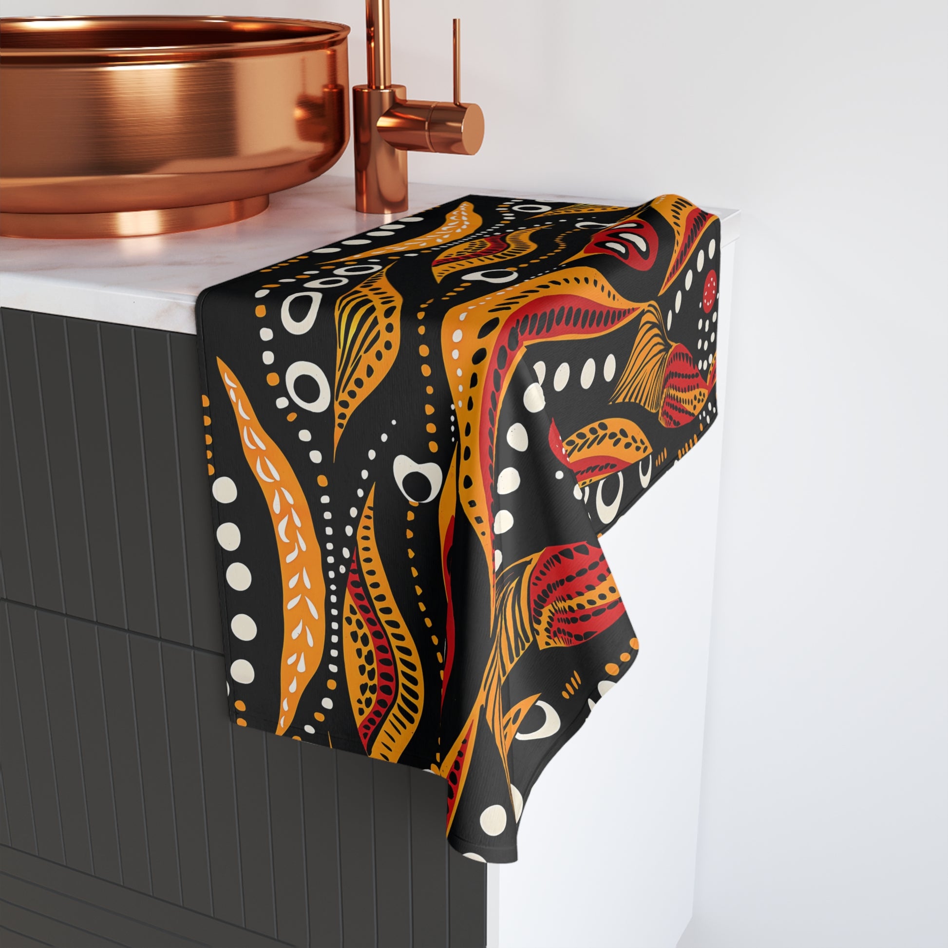 Decorative towel with a colorful pattern draped over a kitchen counter.