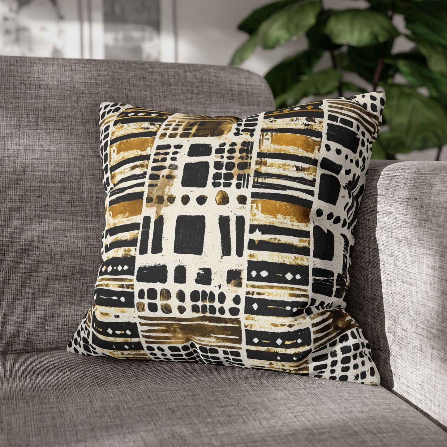 Tribal Print pillow on a gray sofa with a blurred indoor background