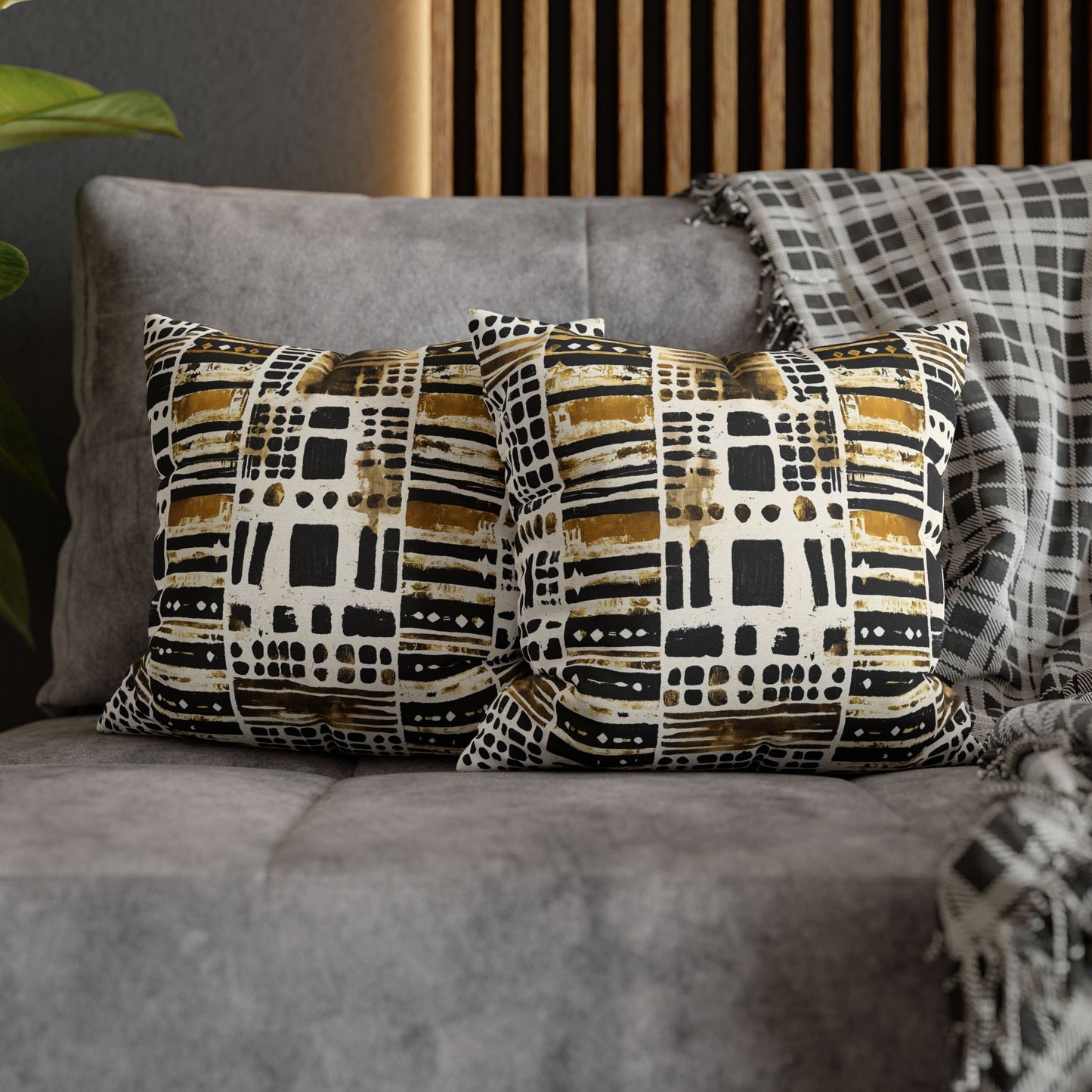 African Patterned cushions on a gray sofa with a wooden headboard in the background