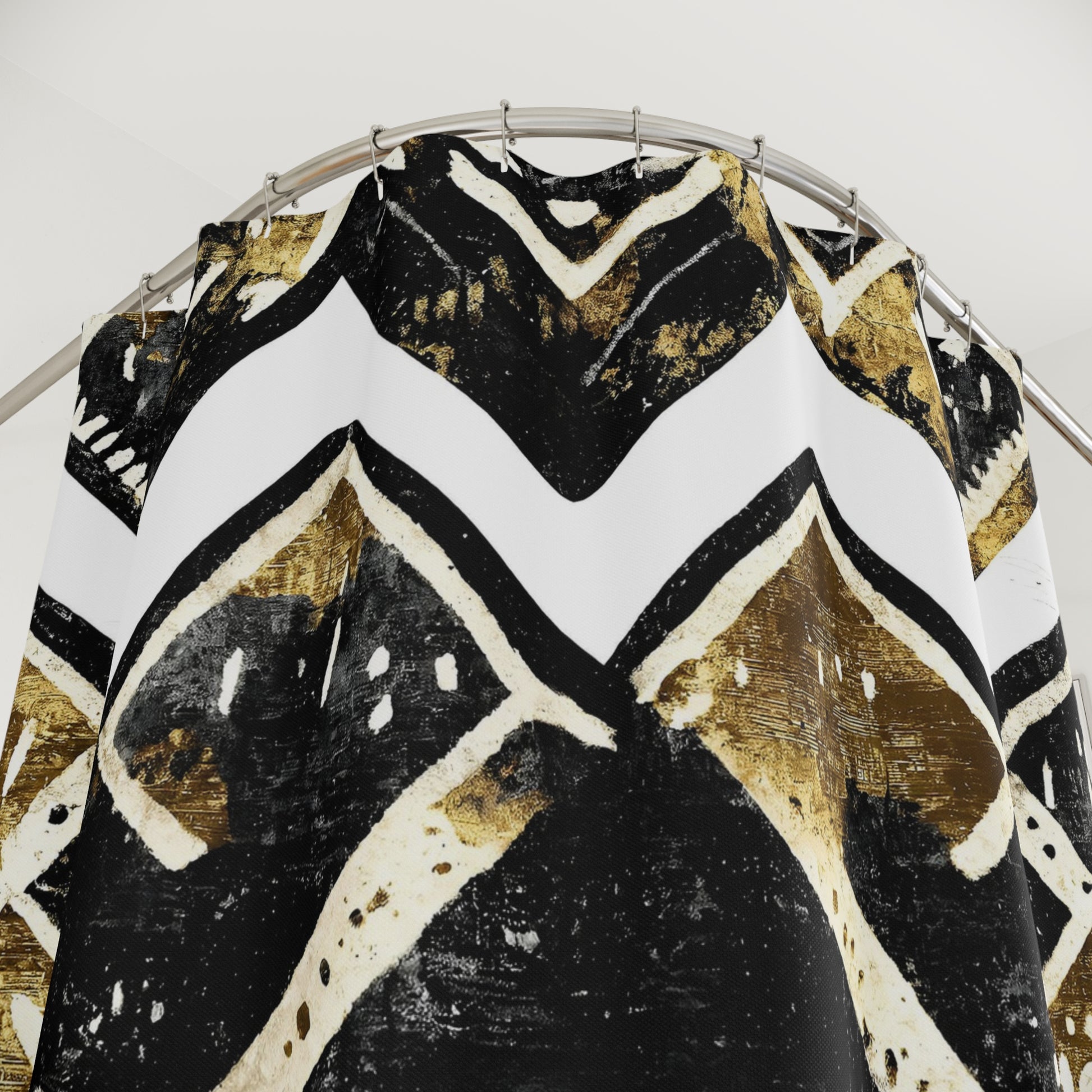 Black, gold, and white patterned top on a hanger against a white background