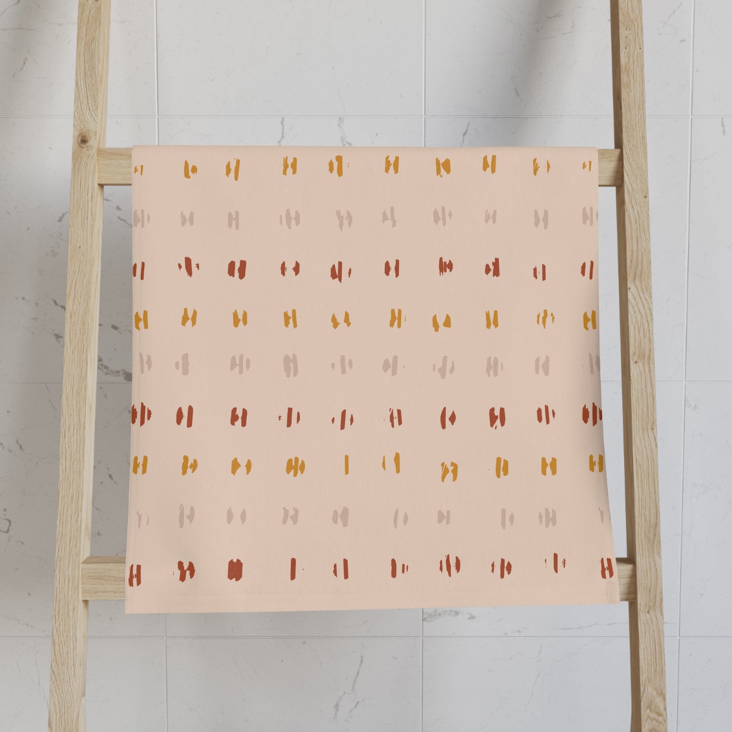 Patterned towel on a wooden ladder against a white wall