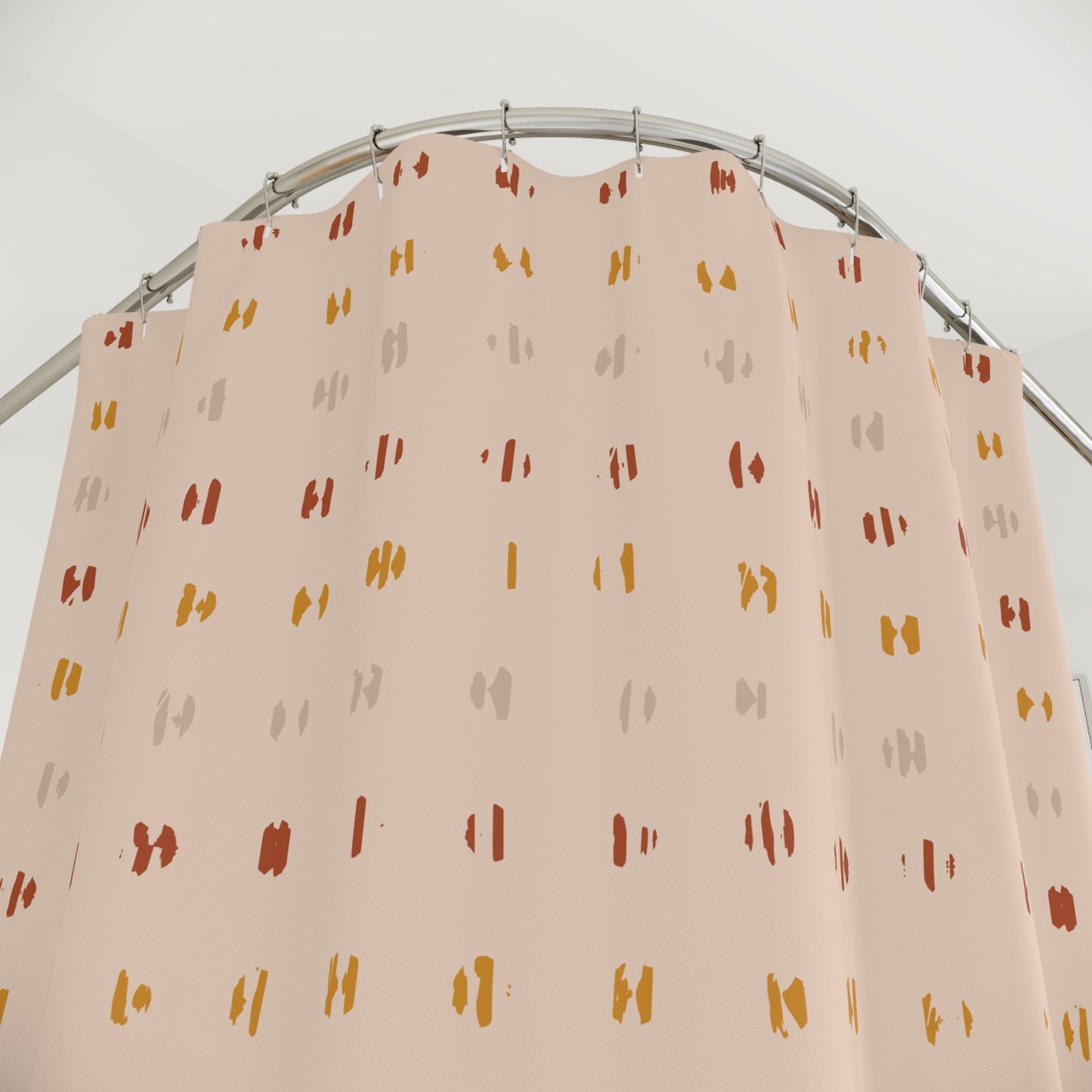 Beige curtain with colorful pattern on a metal rod against a white background