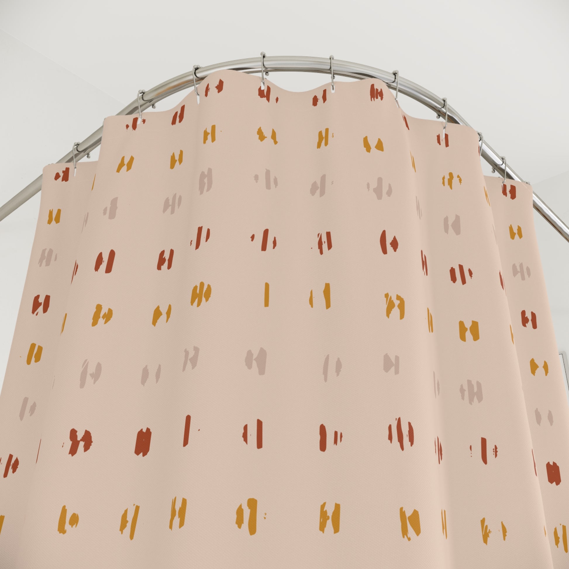 Beige curtain with colorful pattern on a metal rod against a white background