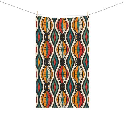 Colorful patterned towel hanging on a line against a white background