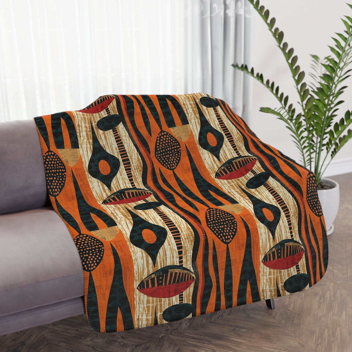 Decorative blanket with abstract pattern draped over a chair in a living room setting.
