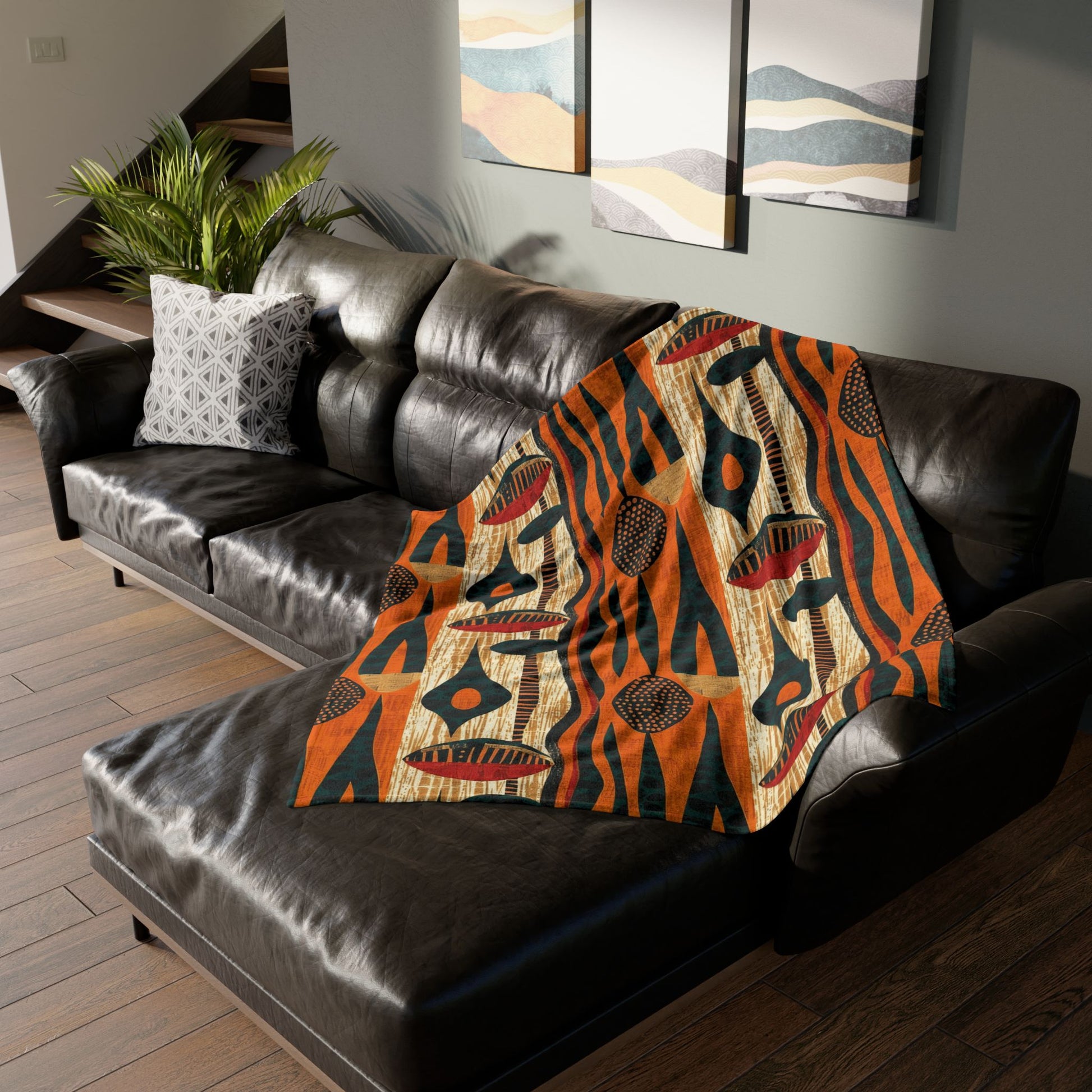 Decorative blanket with a tiger pattern draped over a brown leather sofa in a living room.