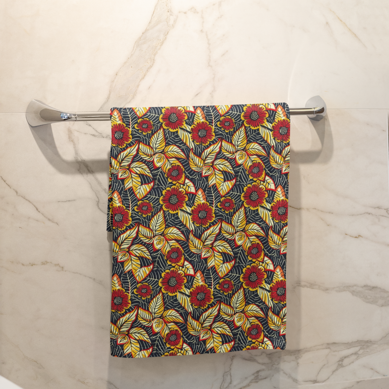 Decorative towel with floral pattern hanging on a towel rack in a bathroom.