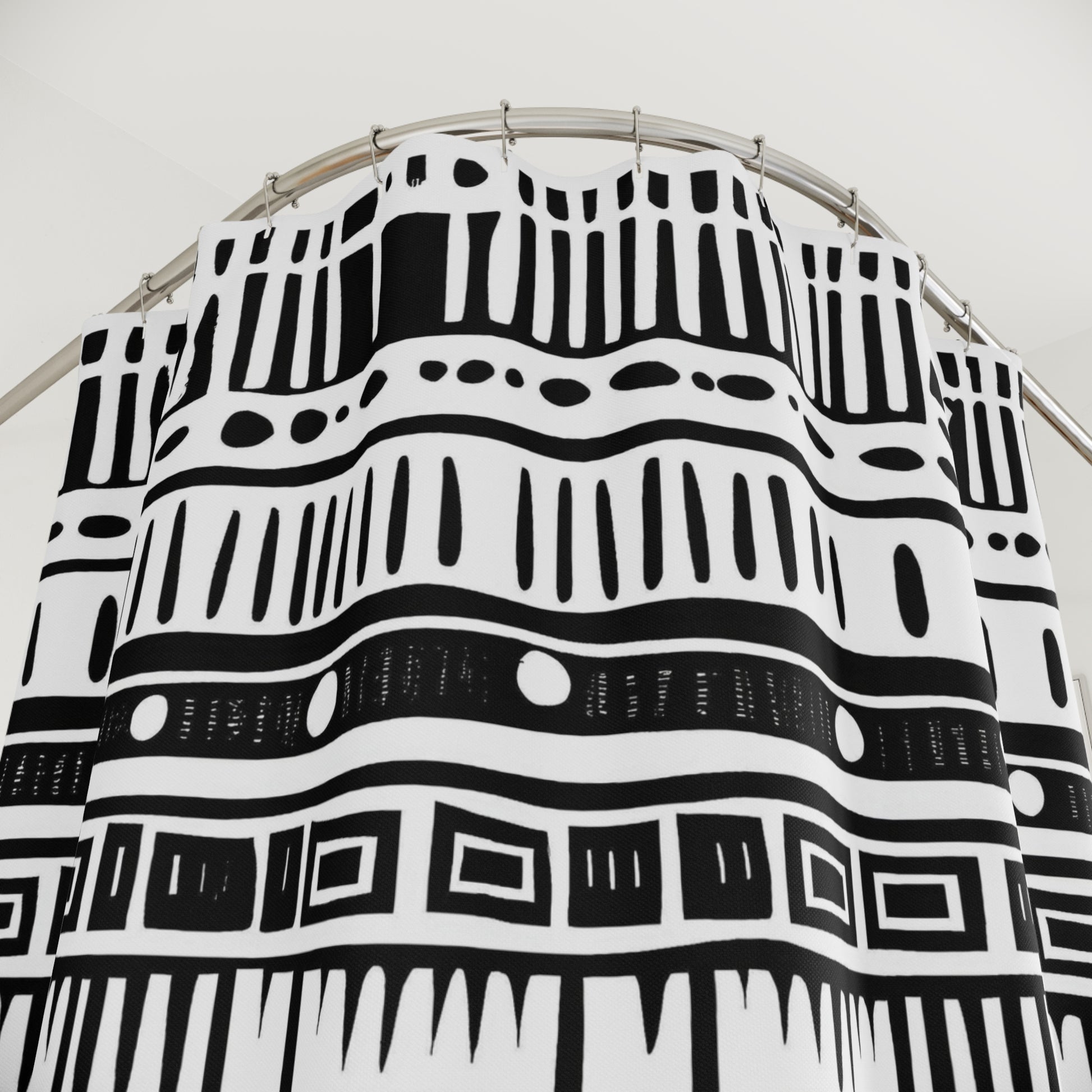 Black and white shower curtains on a circular stand against a white background