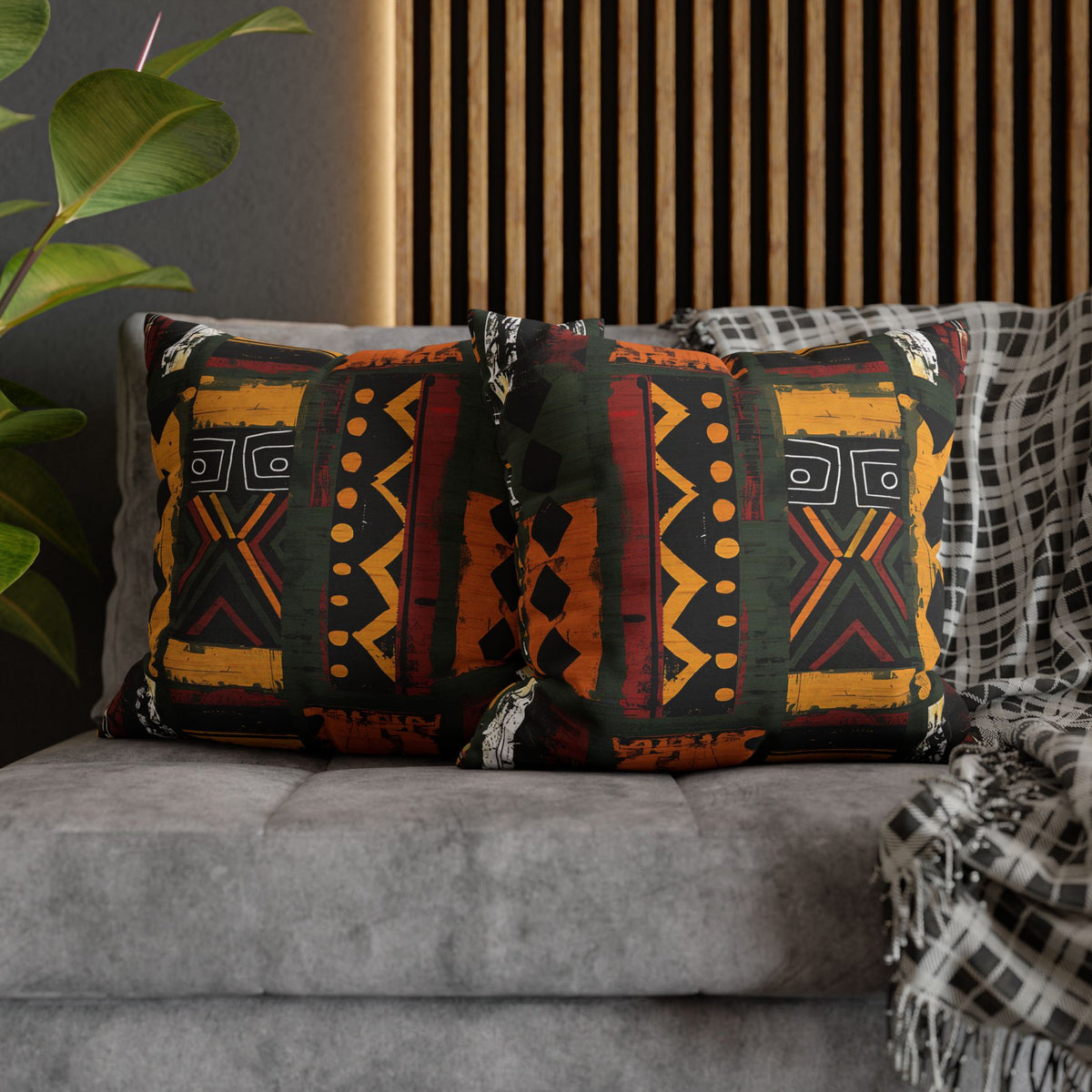 Decorative pillows with tribal patterns on a gray sofa.