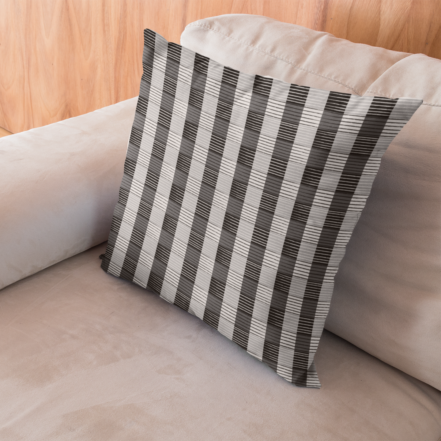 African Plaid Striped pillow on a beige sofa with a light wooden floor.