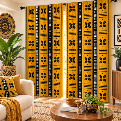 A pair of floor-length window curtains with a bold yellow and black African tribal-inspired pattern, styled in a warm, modern living room setting.
