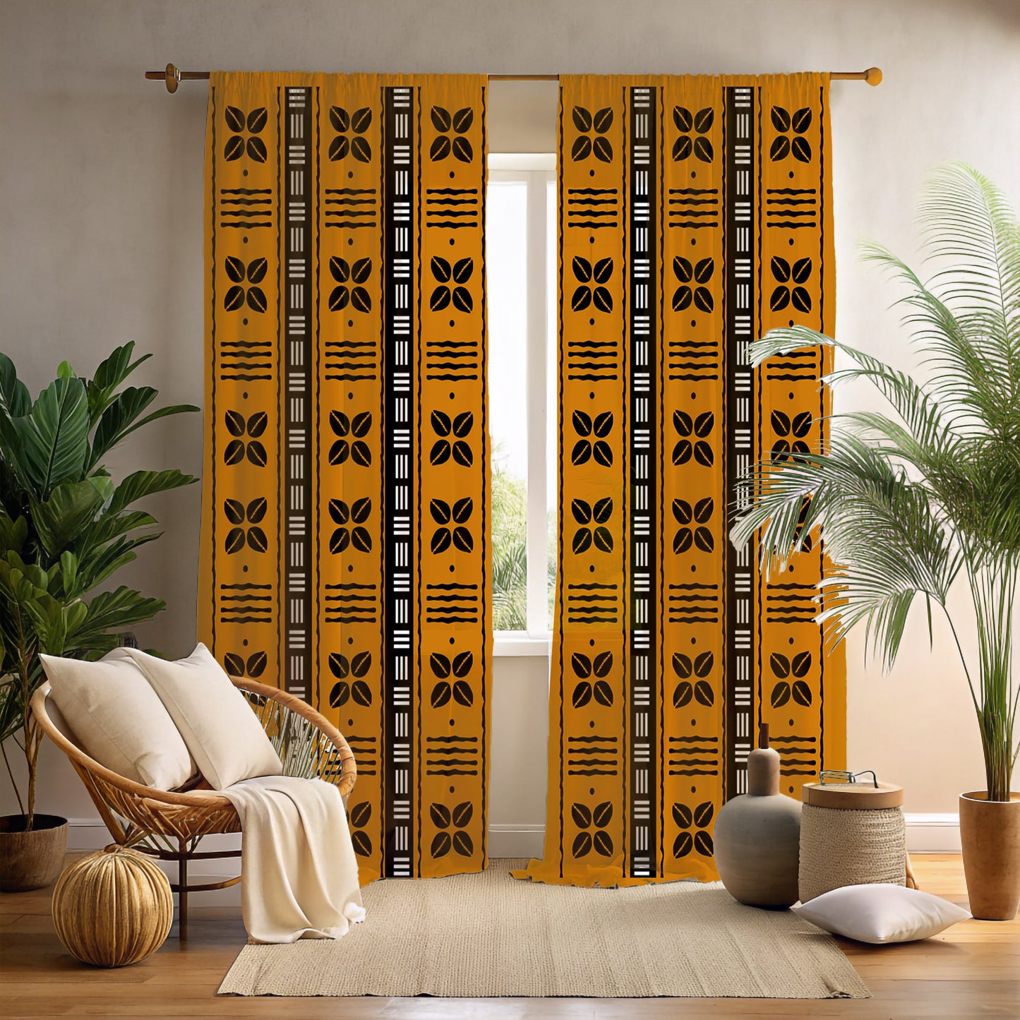 A pair of yellow blackout curtains with black tribal patterns, displayed in a room setting with a chair, cushions, and a plant.