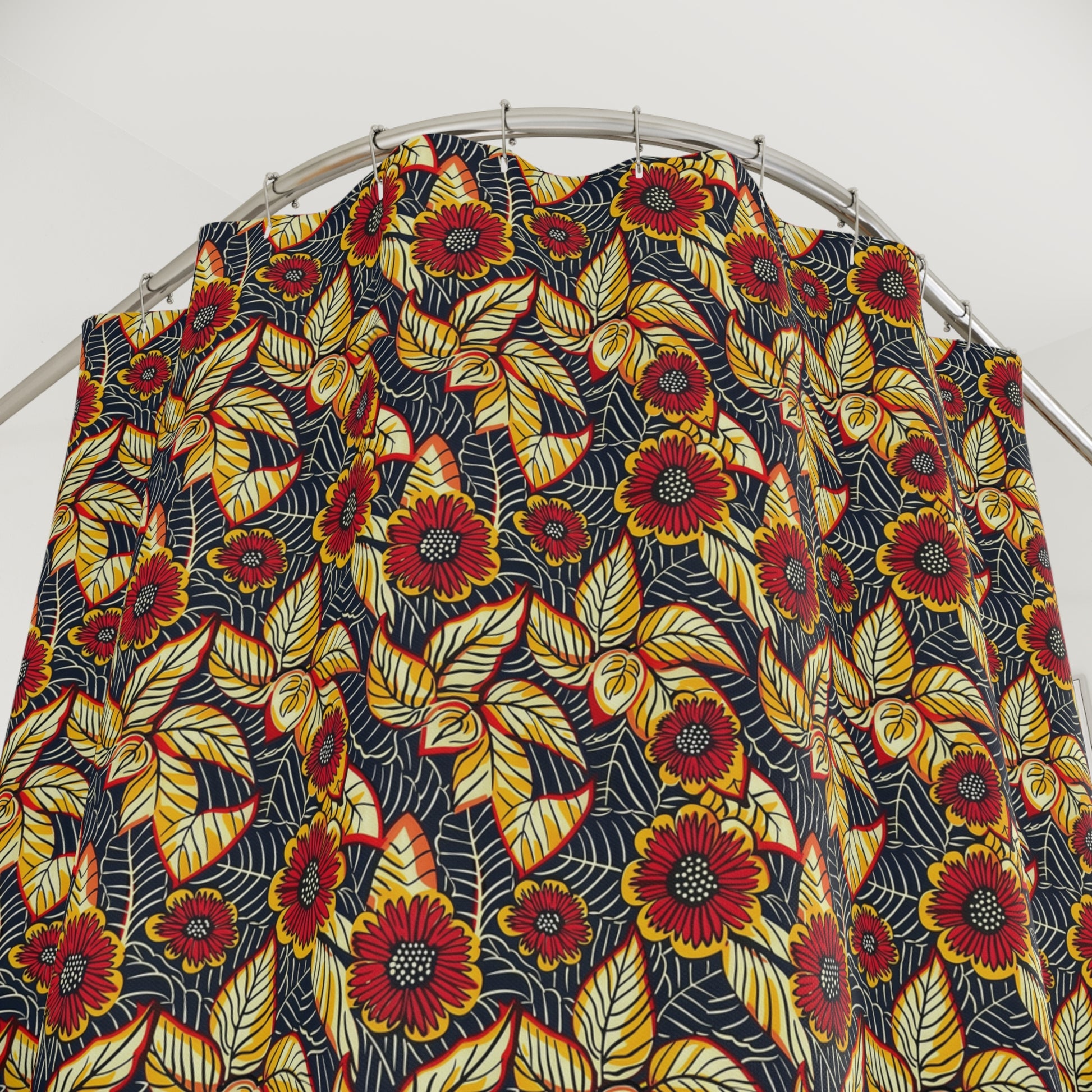 Colorful floral patterned fabric on a metal rod against a white background
