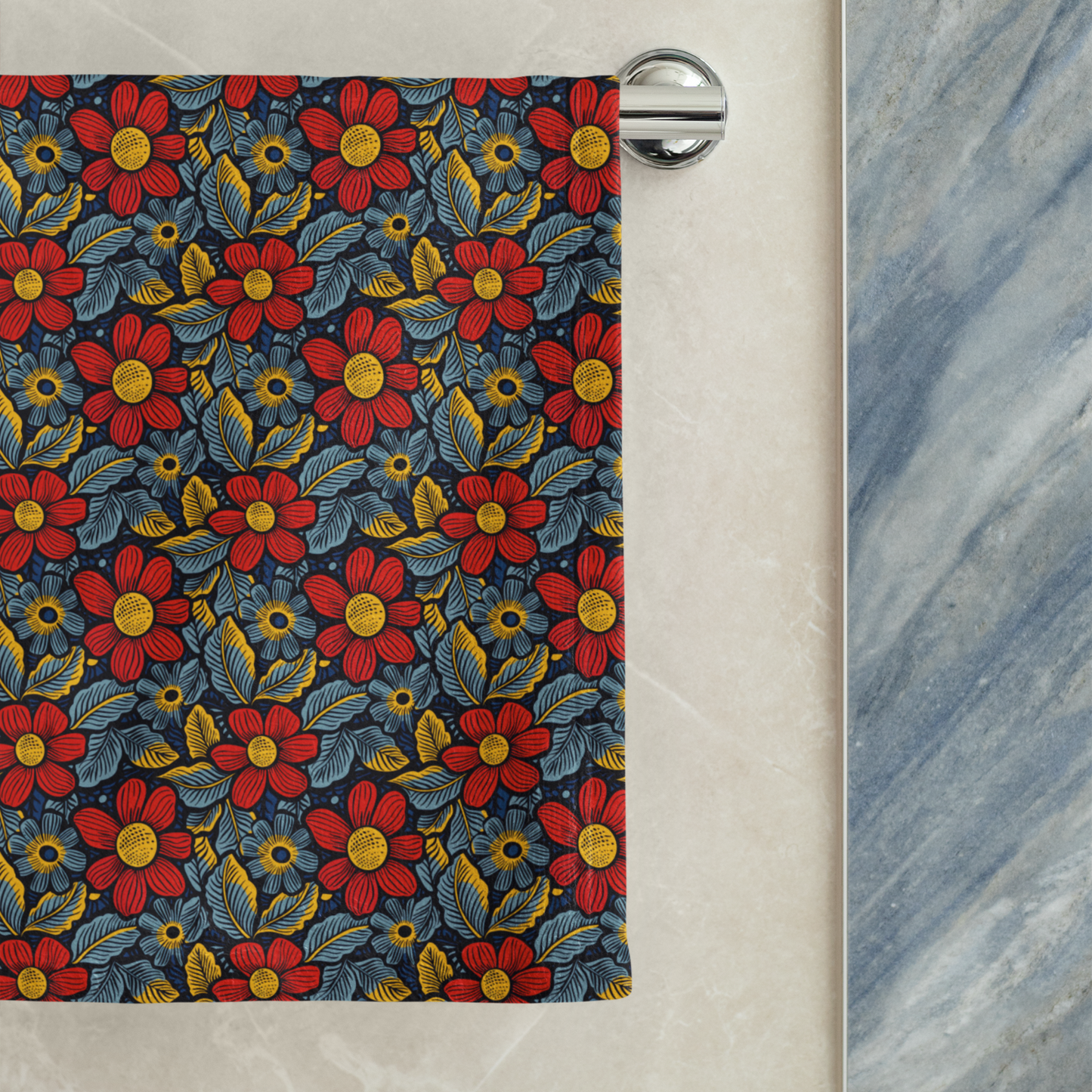 Floral patterned towel hanging on a rack against a marble wall.