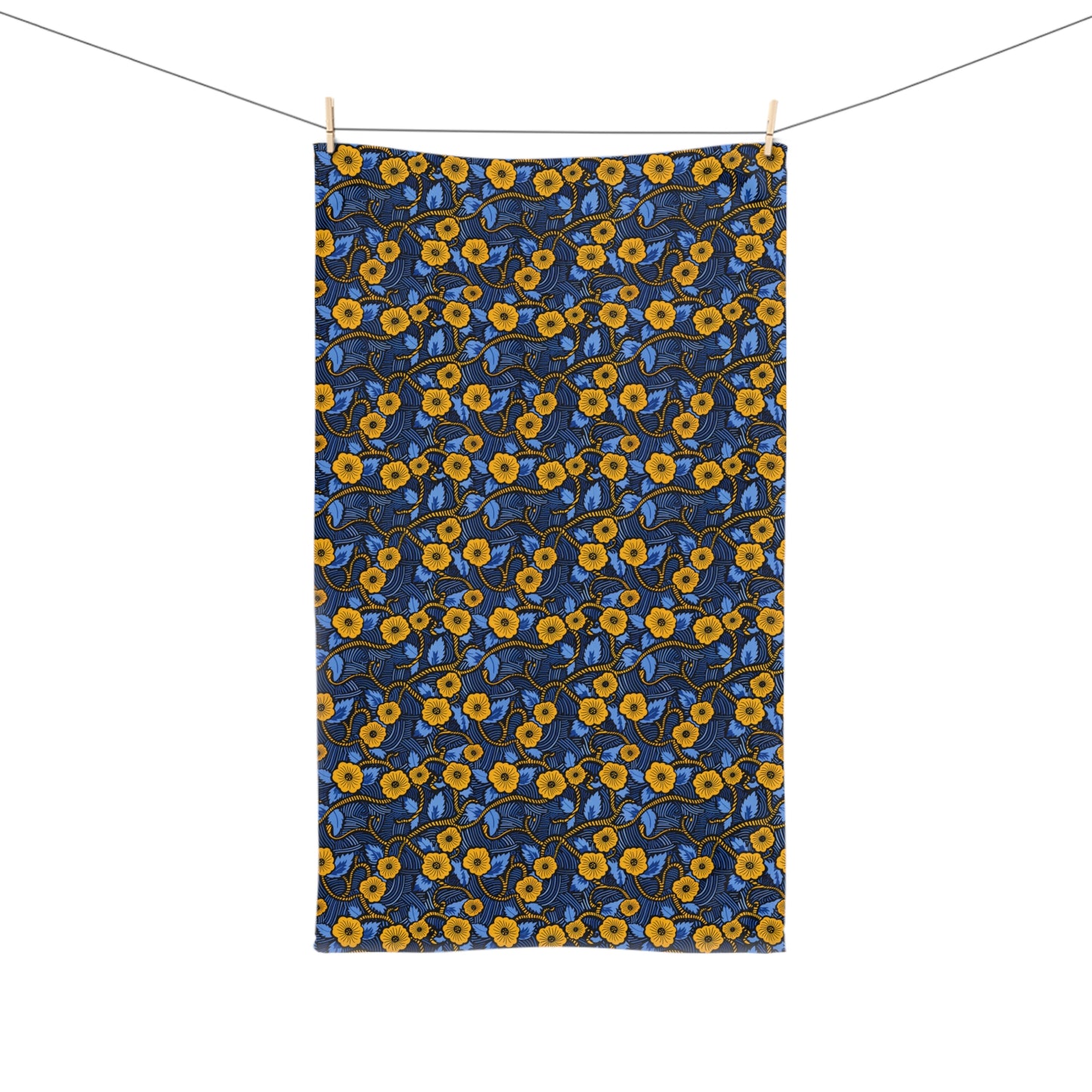 Floral patterned towel hanging on a line with a white background