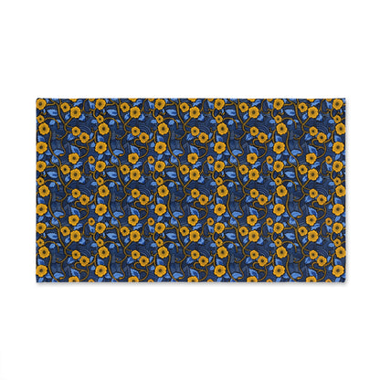 Decorative hand towel with a blue and yellow floral pattern on a white background