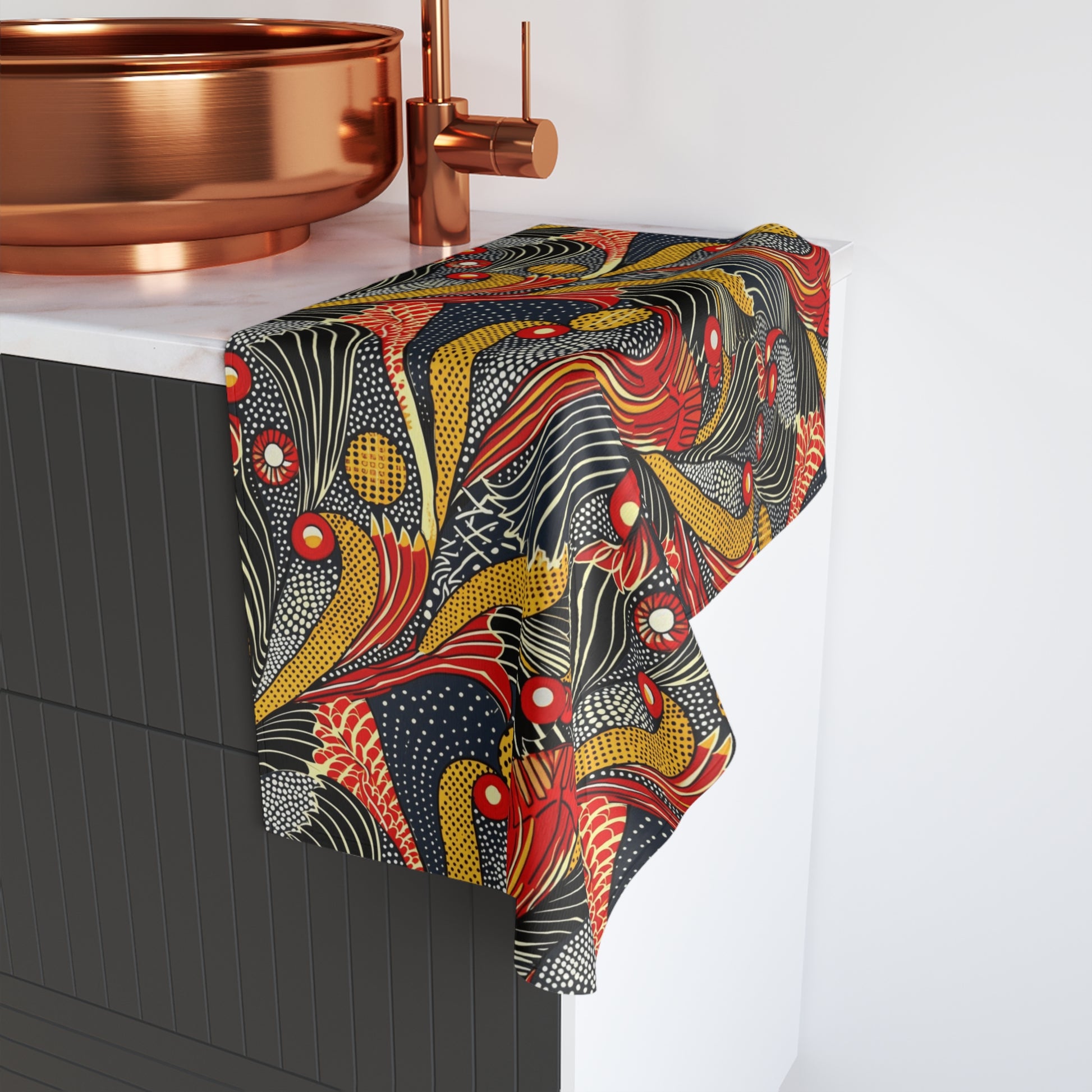 Colorful patterned towel draped over a bathroom cabinet with copper fixtures.