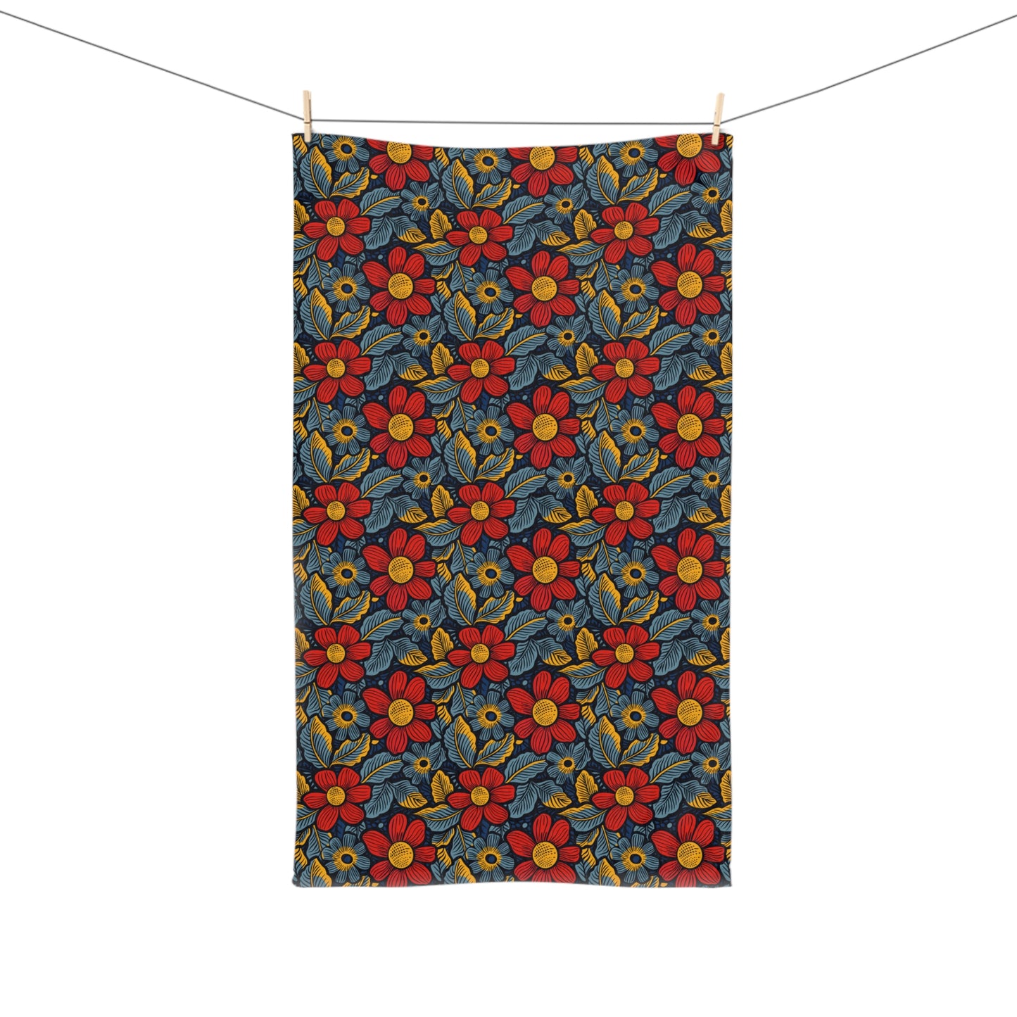 Floral patterned towel hanging on a line with a white background