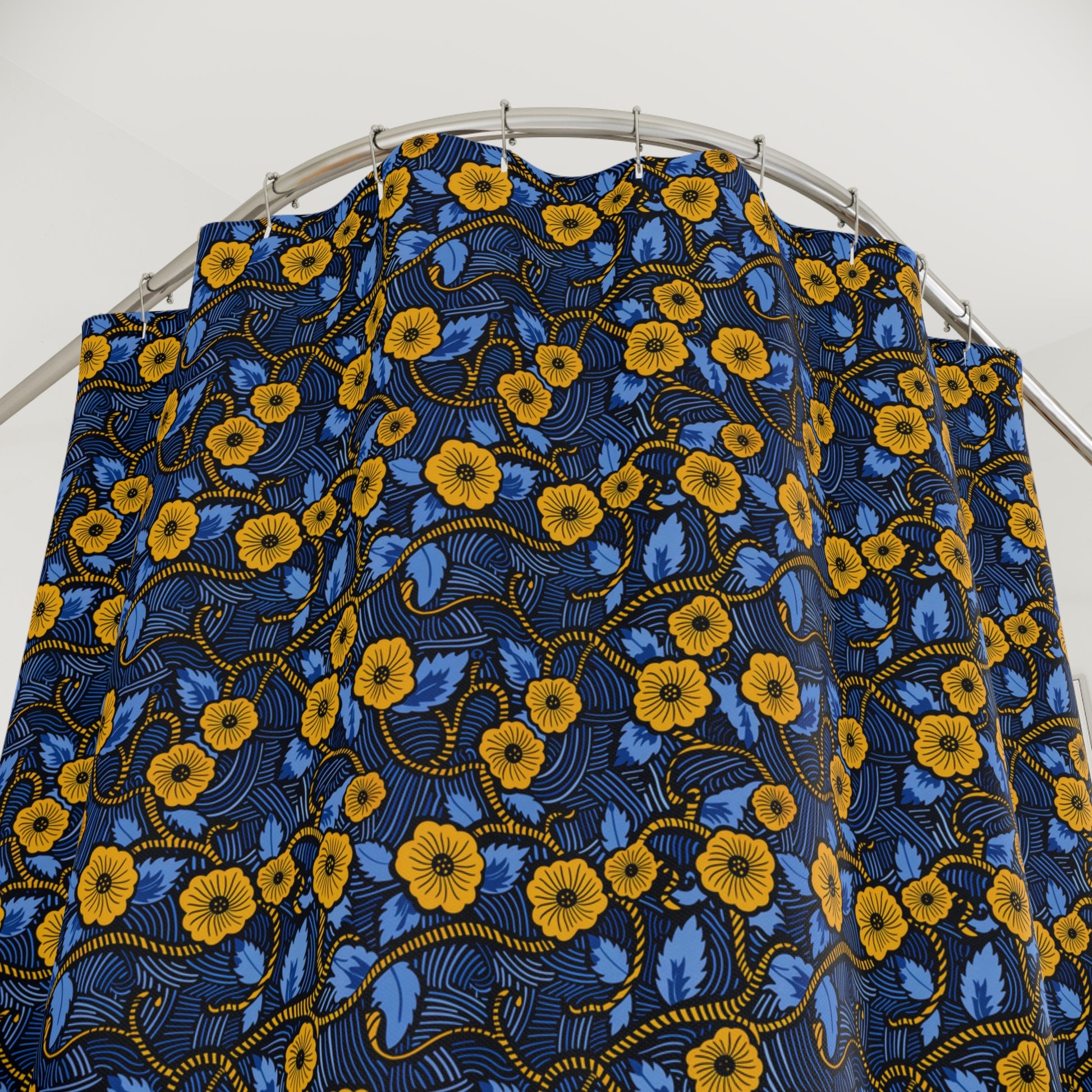 Blue and yellow floral fabric on a metal rod against a white background