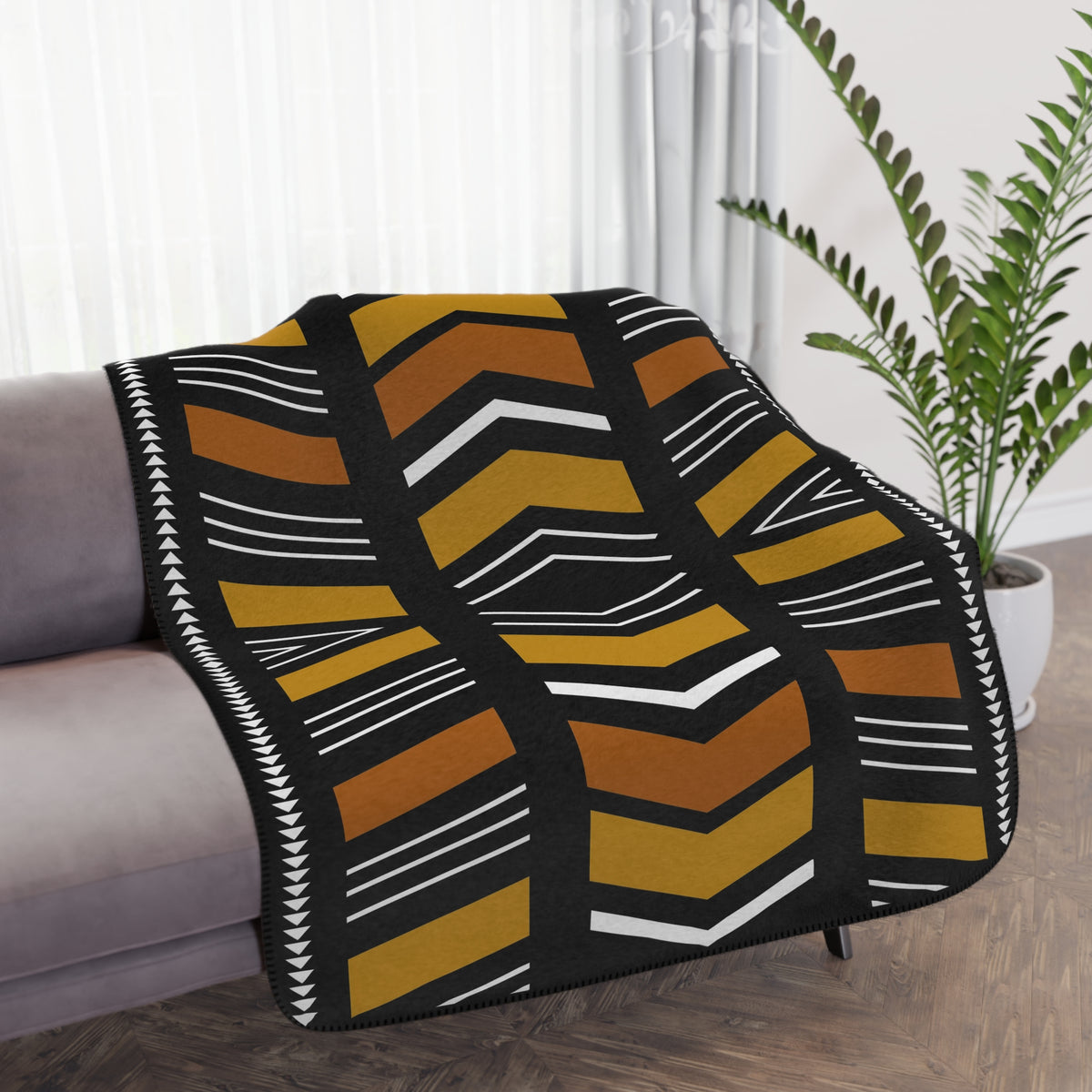 Geometric patterned throw blanket on a sofa in a living room setting