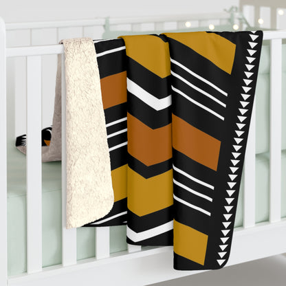 Colorful patterned blanket draped over a white crib