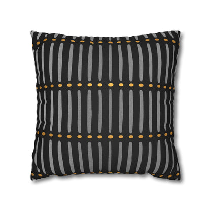 Decorative pillow with black, gray, and yellow pattern on a white background