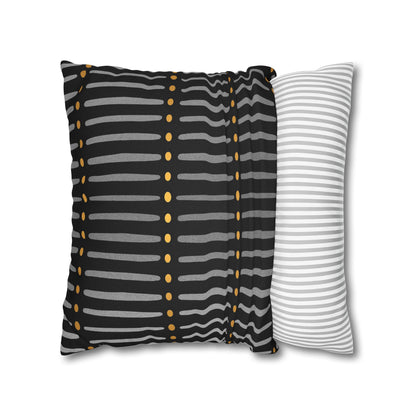 Two striped pillows, one with black, gray, and gold pattern and the other with white and gray stripes, on a white background.