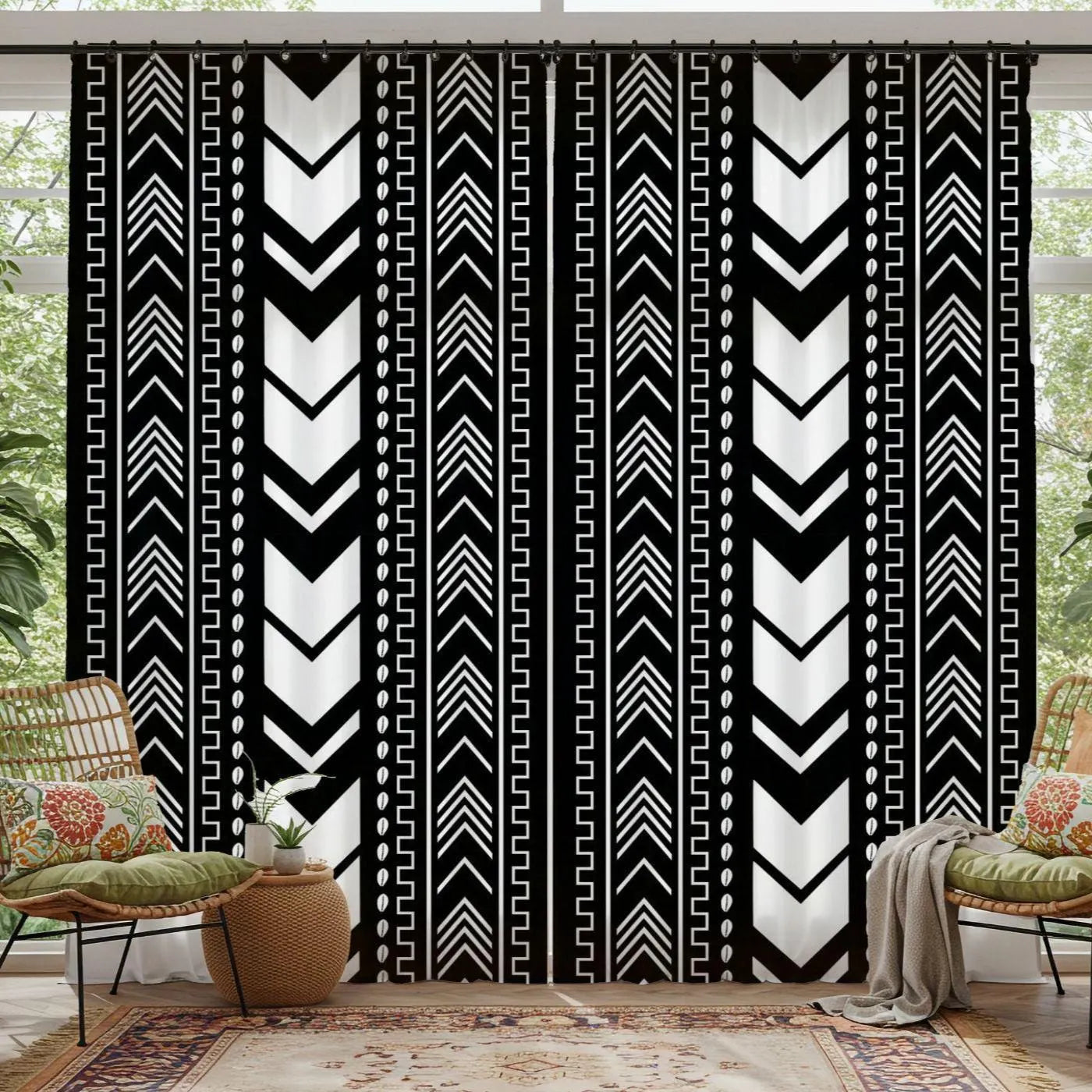 Black and white patterned curtains in a room with chairs and decor.