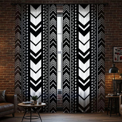 Black and white patterned curtains in a room with a brick wall.