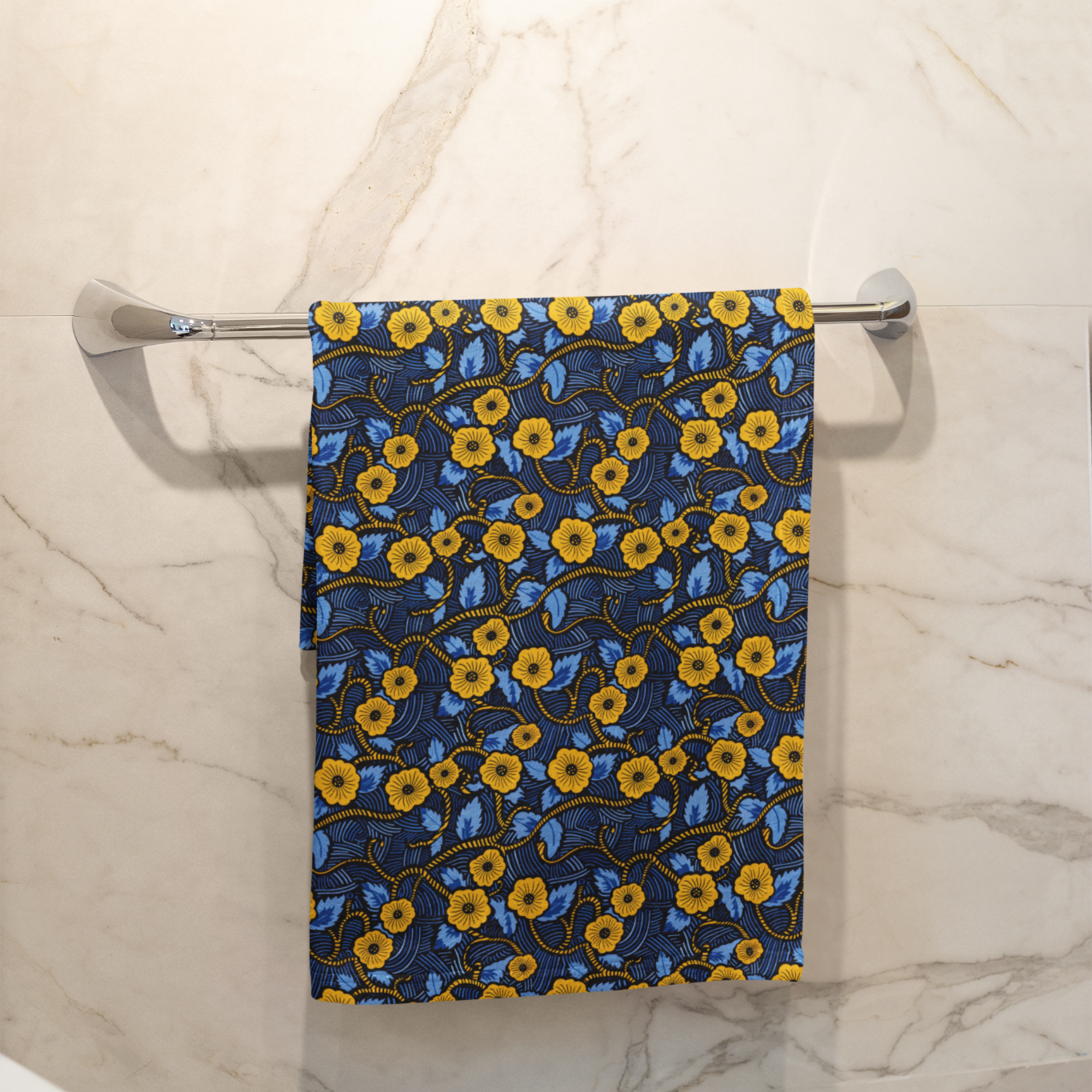 Floral-patterned towel hanging on a rack in a bathroom.