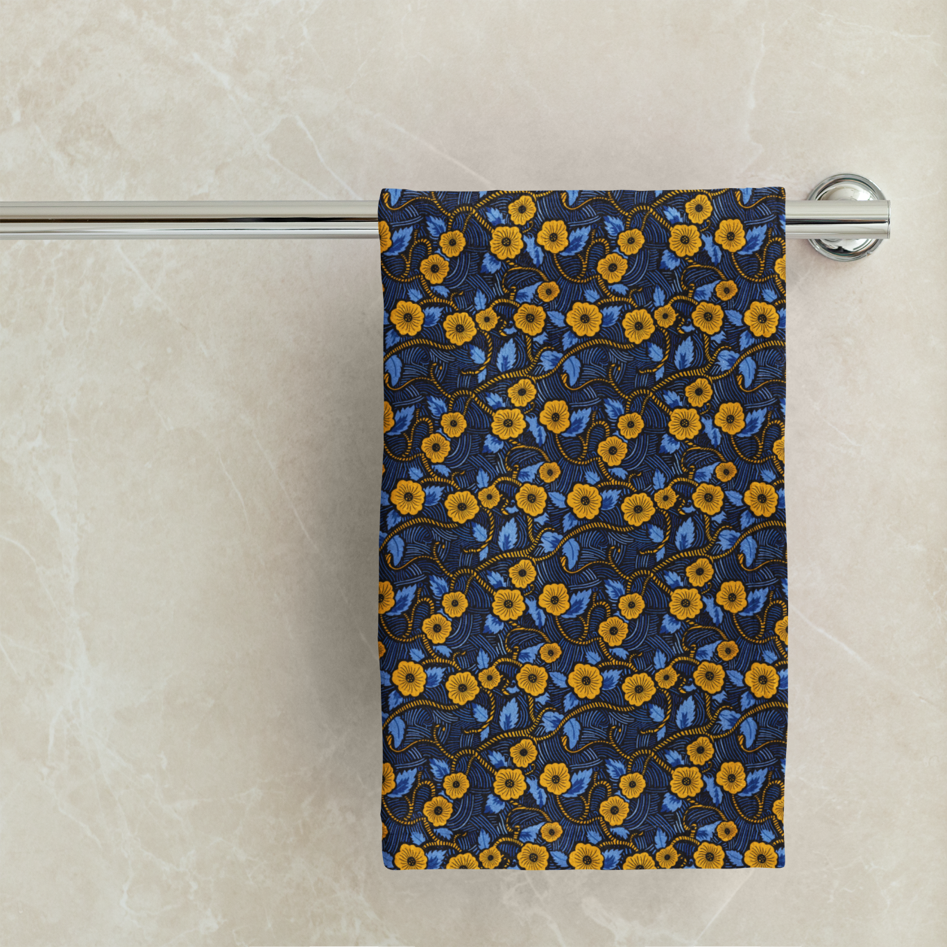 Floral-patterned towel hanging on a rack against a marble wall.