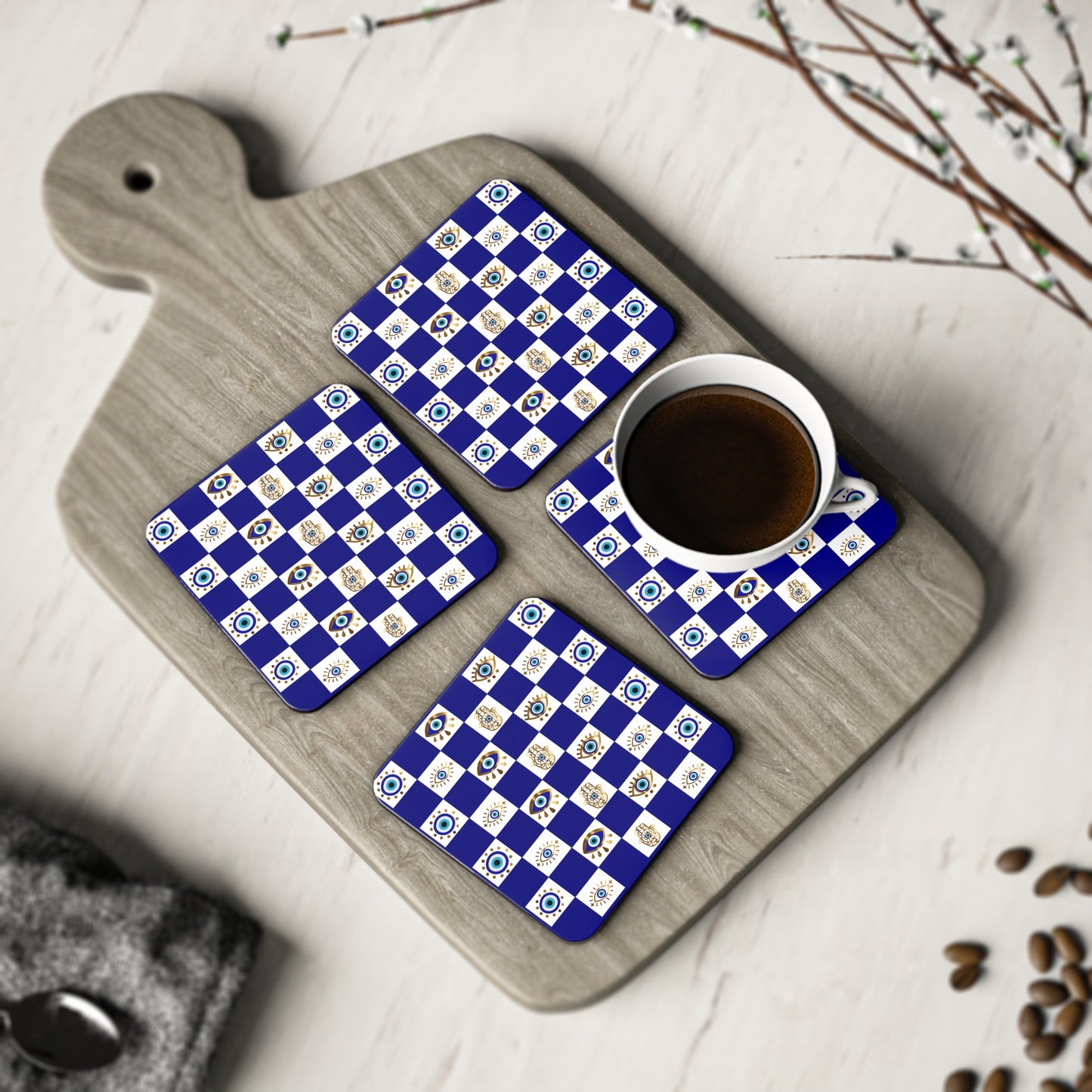 Set of four blue and white checkered coasters on a wooden cutting board with a cup of coffee.