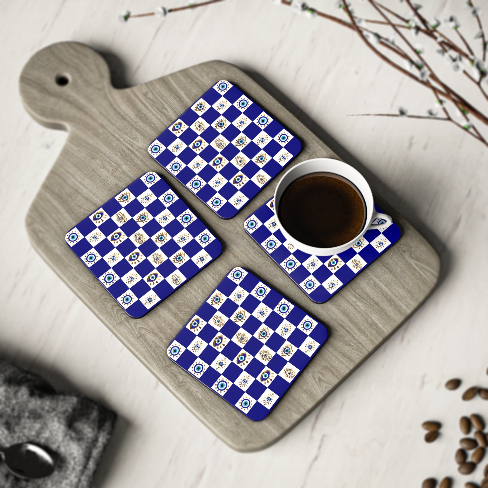 Set of four blue and white checkered coasters on a wooden cutting board with a cup of coffee.