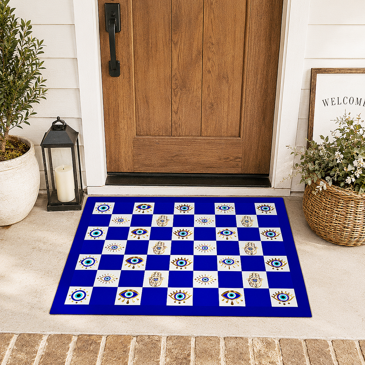 A rectangular doormat with a royal blue and white checkerboard pattern featuring evil eye and hamsa motifs, placed in front of a wooden front door on a porch with potted plants and a lantern.