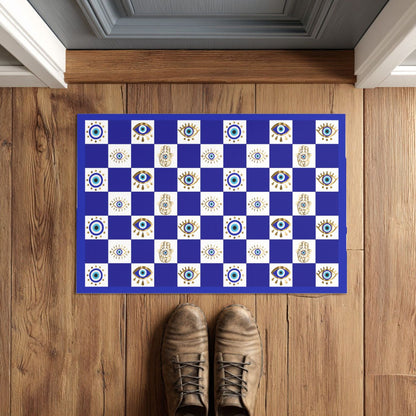 Blue and white checkered doormat with eye design on a wooden floor.