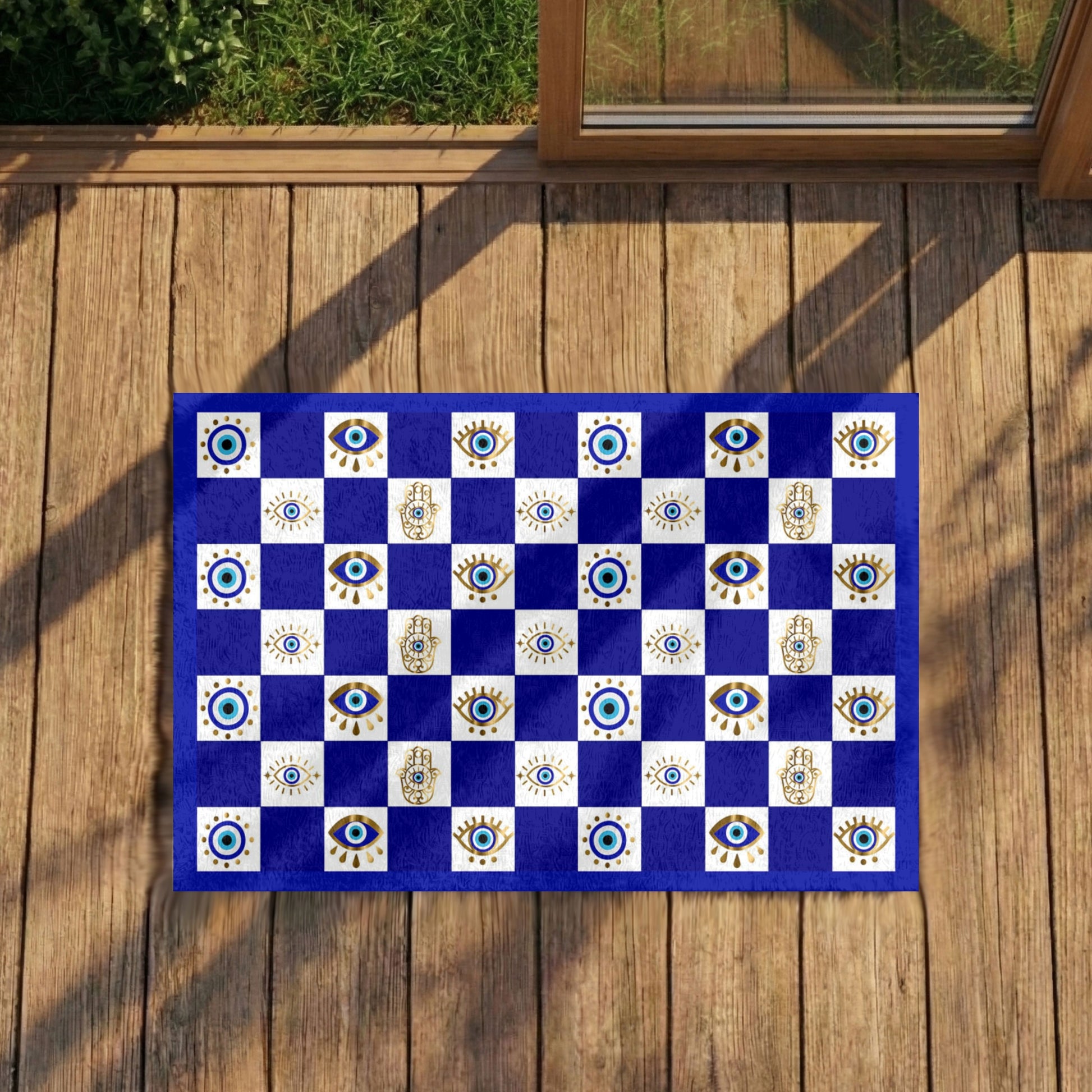 Checkered mat with eye patterns on a wooden deck