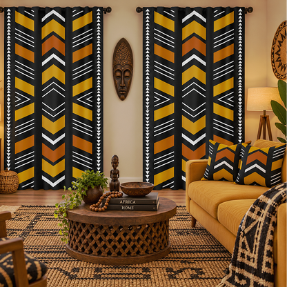 A styled living room featuring two tall window curtains with a bold African-inspired geometric pattern in black, mustard yellow, orange, and white. The room is decorated with a yellow sofa, a carved wooden coffee table, a patterned rug, and a warm, cozy ambiance.