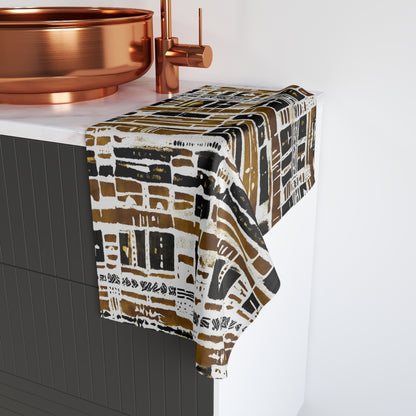 Patterned towel draped over a bathtub with copper fixtures.