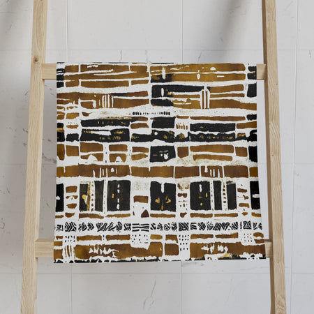 African print towel with abstract pattern on a wooden ladder against a white wall