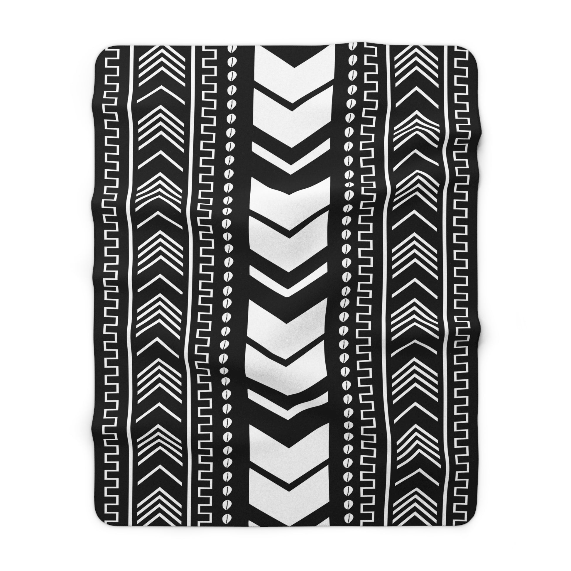Black and white patterned blanket with zigzag and line designs on a white background