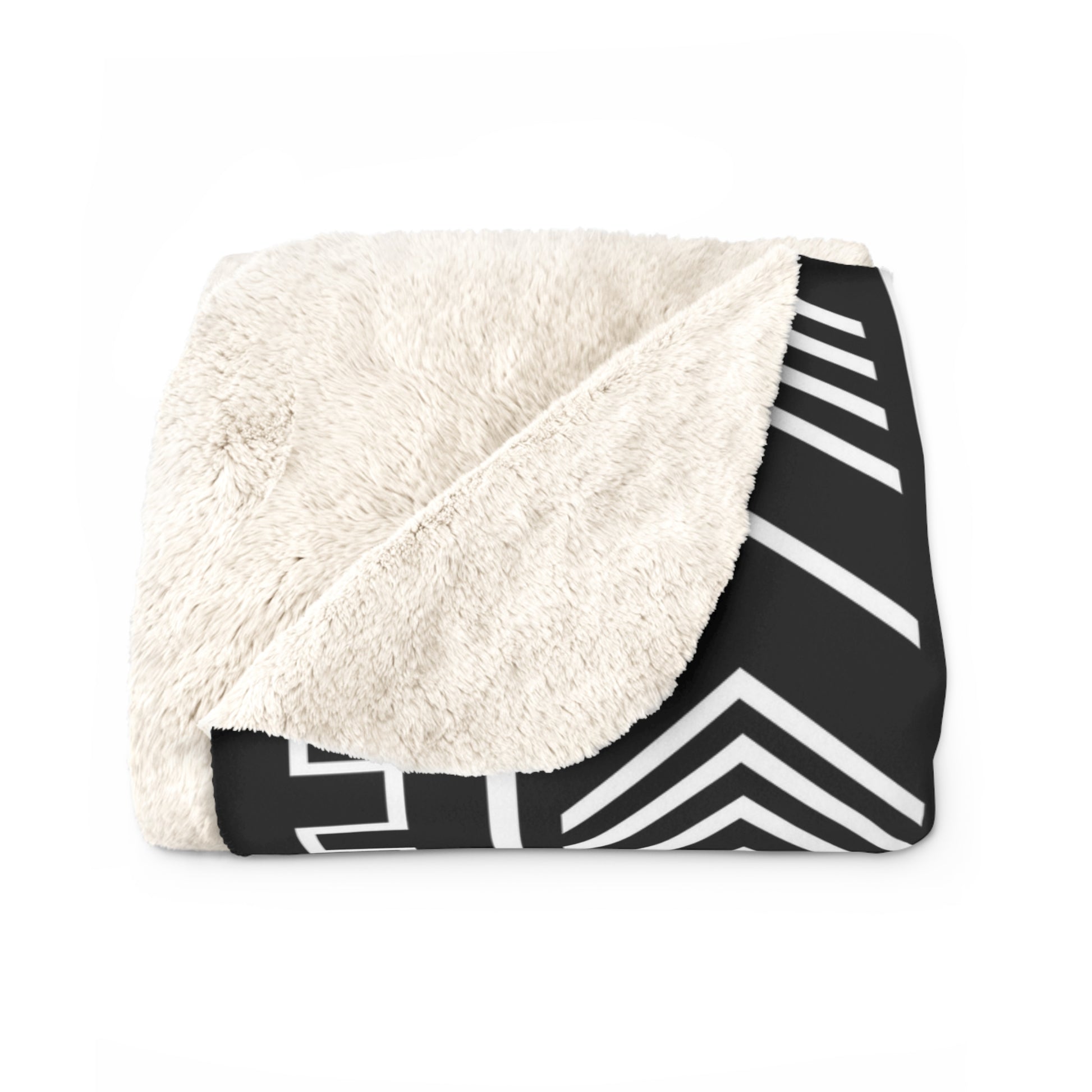 Blanket with white sherpa interior and black and white chevron pattern exterior on a white background