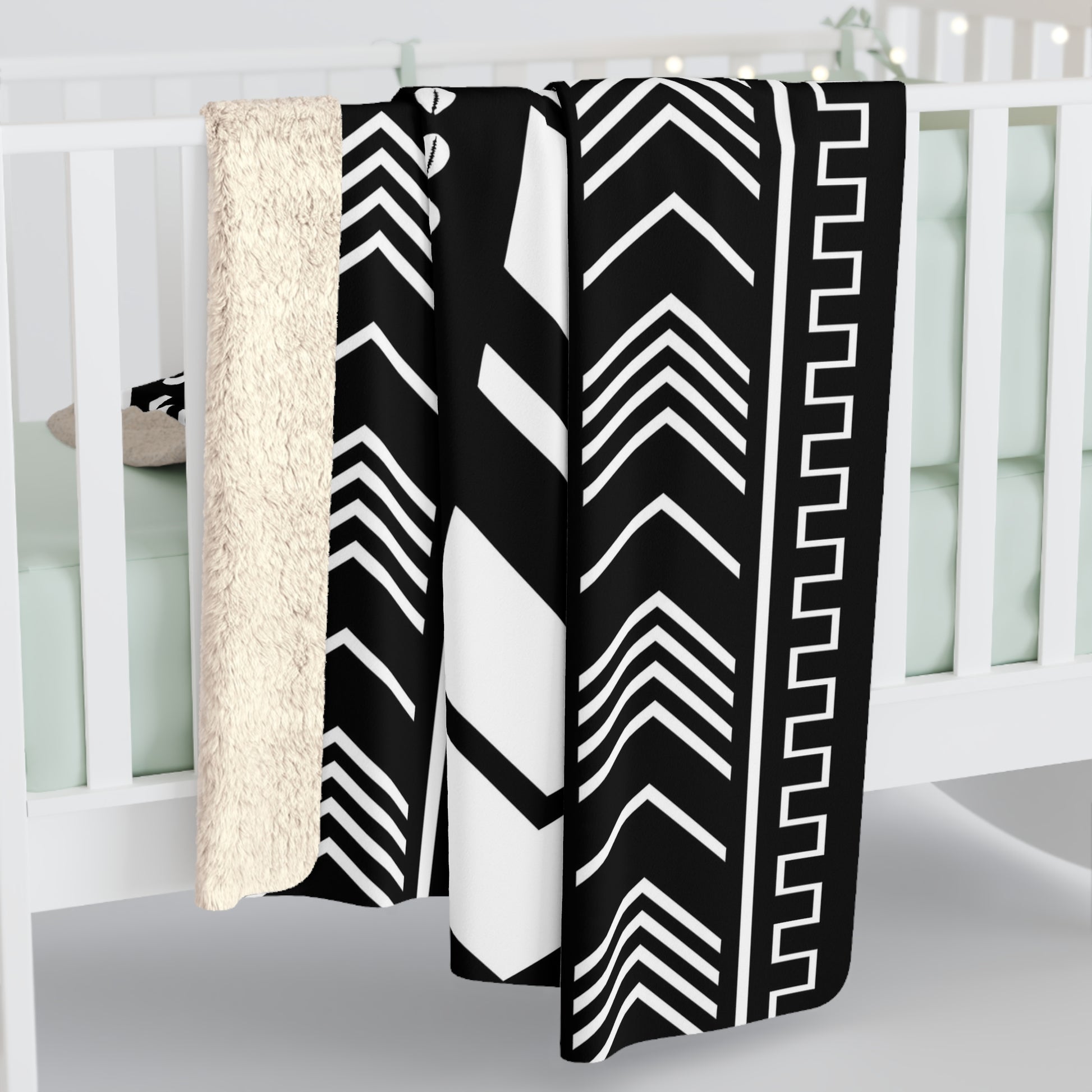 Bogolan Mudcloth patterned blanket draped over a crib
