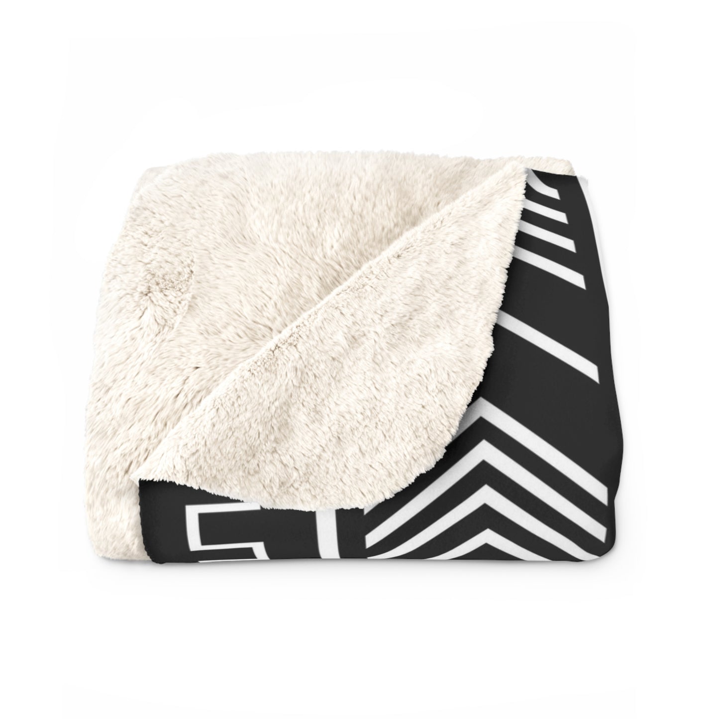 Folded blanket with white sherpa interior and black and white chevron pattern exterior on a white background