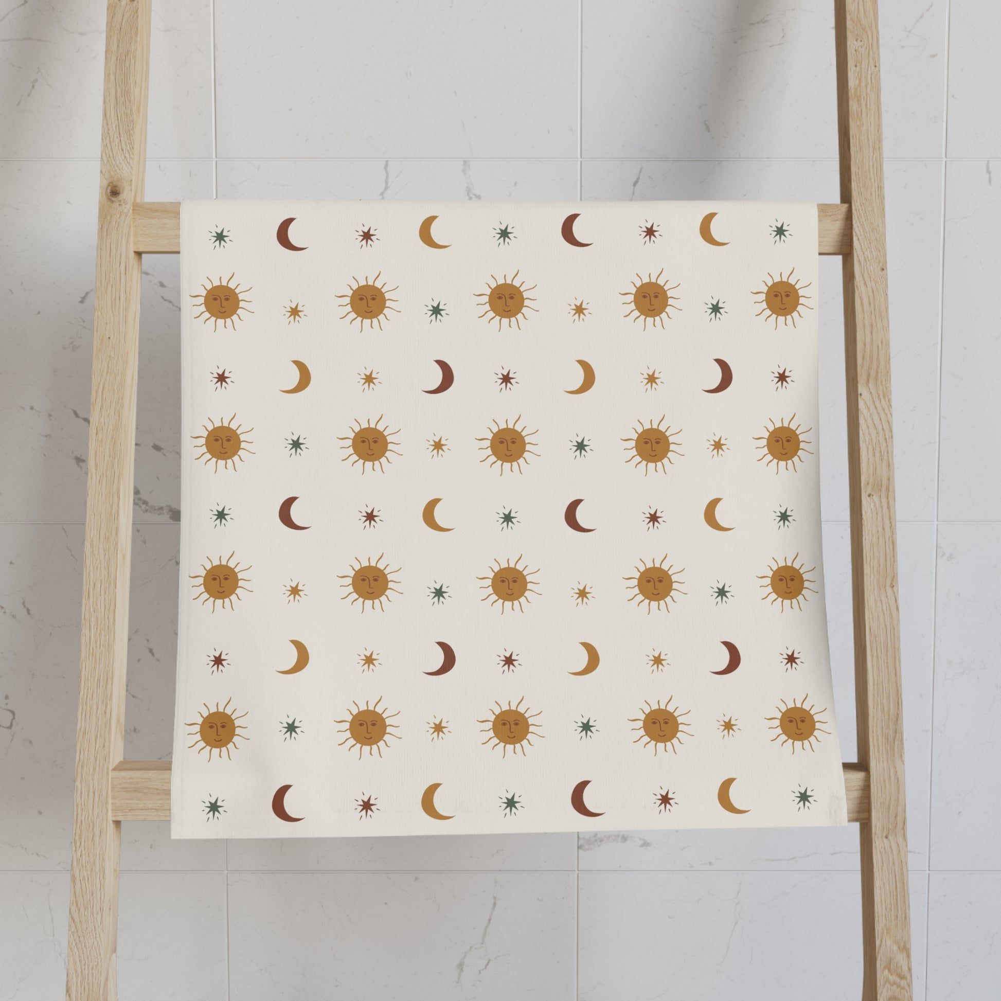 Hand Towel with celestial pattern on a wooden ladder against a white wall